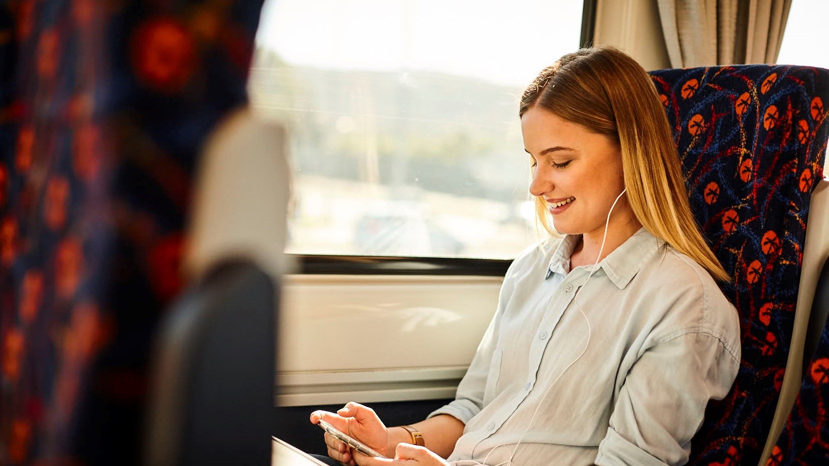 Girl on train wearing headphones